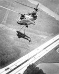 Chinook helicopter hauls a rocket launcher over the autobahn, 1979